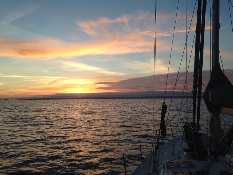 Sunrise approaching the English coast seen from a sailing yacht