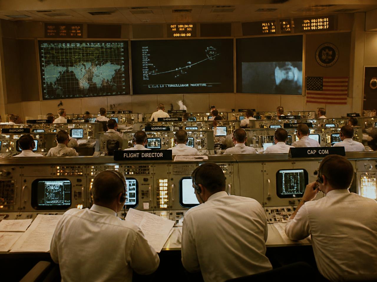 Specialists working together at consoles in a mission control room